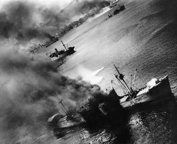 Japanese transport ships in the harbor at Rabaul suffer hits and near misses from U.S. bombers.