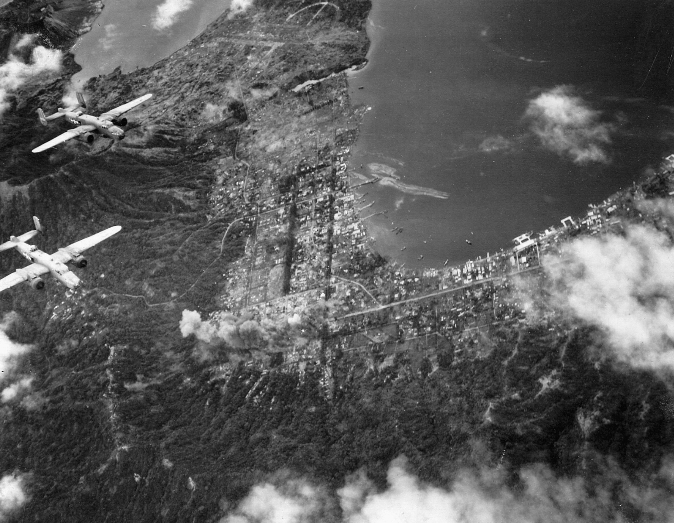 U.S. B-25 Mitchell bombers of the 13th Air Force wing their way above the Japanese bastion at Rabaul in March 1944. The major Japanese supply base and staging area was repeatedly bombed during the American offensive in the South Pacific.