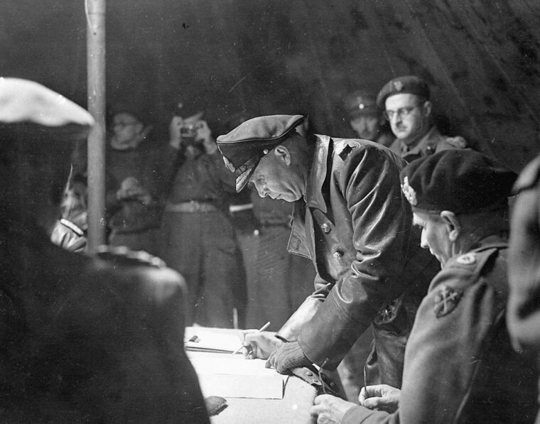 Colonel Johannes Blaskowitz signs formal surrender papers.