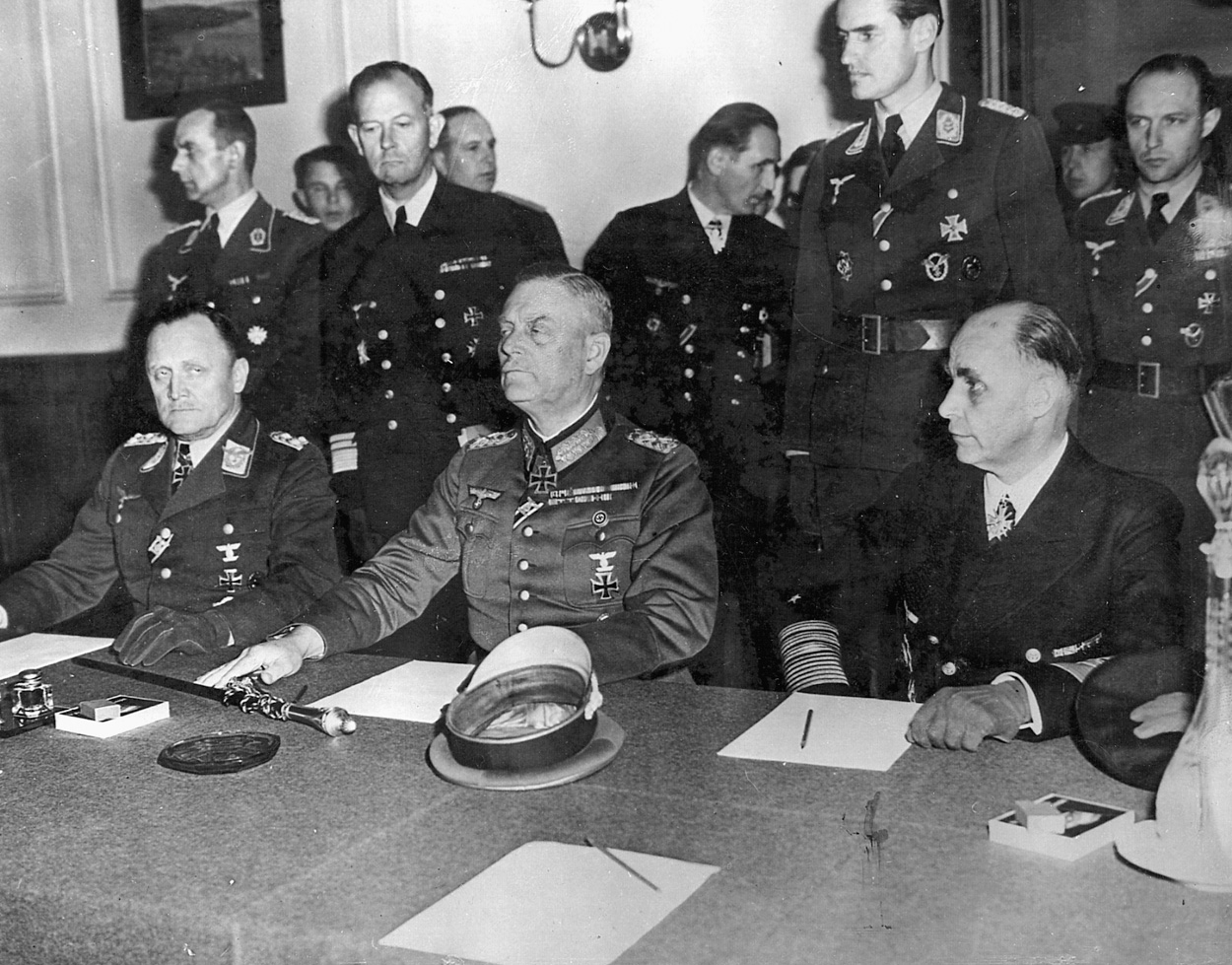 Col. Gen. P.F. Stampf and Field Marshal Wilhelm Keitel sign surrender papers at Russian headquarters in Berlin.