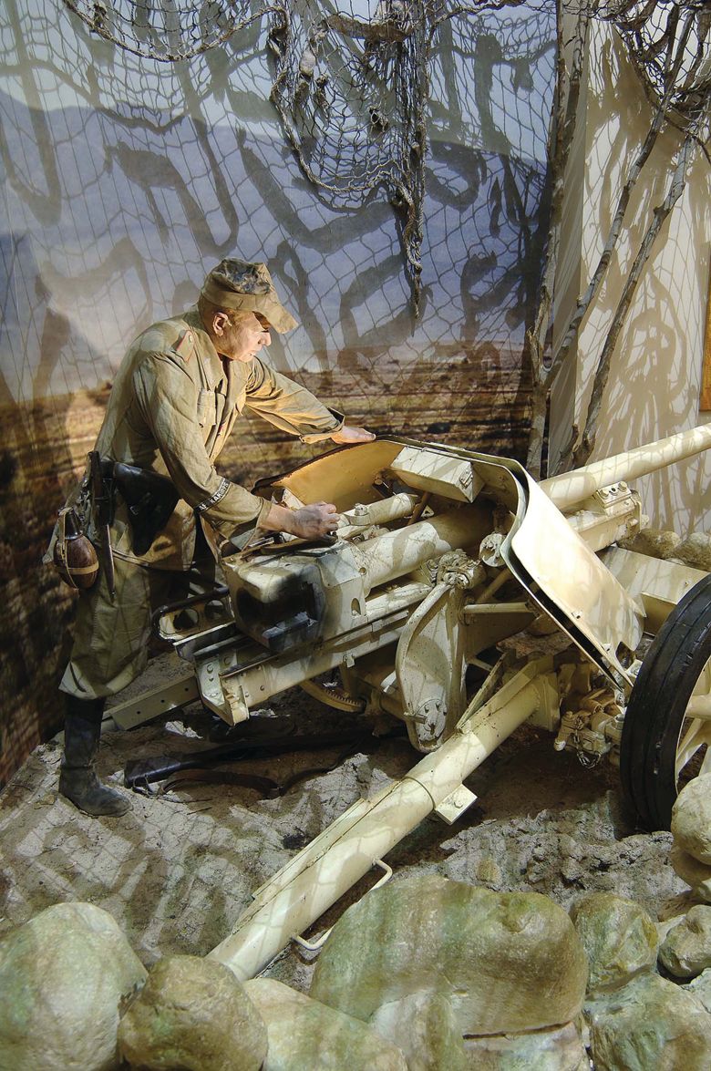In the North Africa Gallery, a German Afrika Korps mannequin mans an antitank weapon.