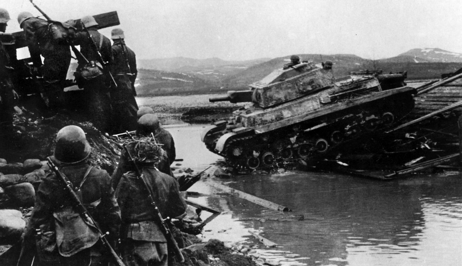 Hungarian panzergrenadiers accompany a Turan II across a stream in Russia in 1944.