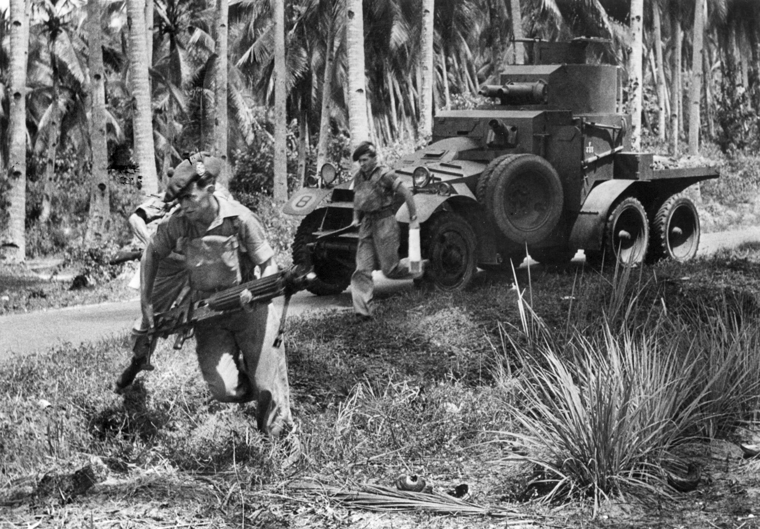 Members of the jungle-trained 2nd Battalion, Argyle and Sutherland Highlander Regiment, on maneuvers. The vehicle is a Lanchester 6x4 Mark I armored car. The soldier in the foreground carries a Vickers Mark VI machine gun.