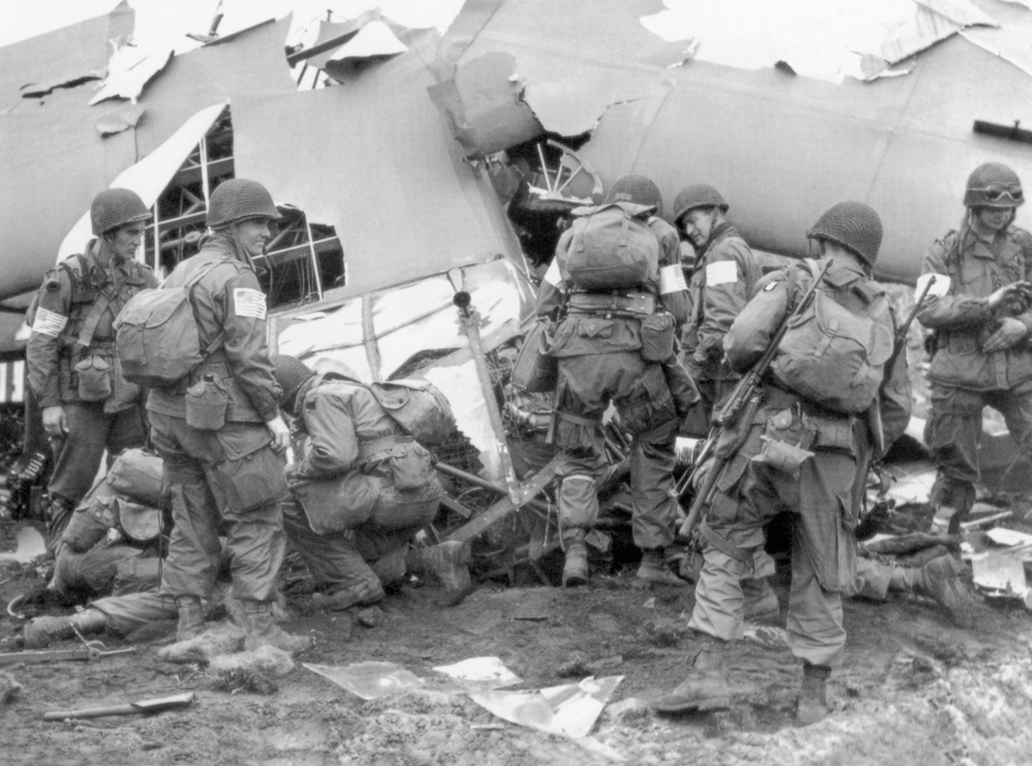 Gliderborne soldiers of the U.S. 82nd Airborne Division unload their wrecked aircraft after what amounted to a controlled crash in a Dutch field during the opening hours of Operation Market-Garden.