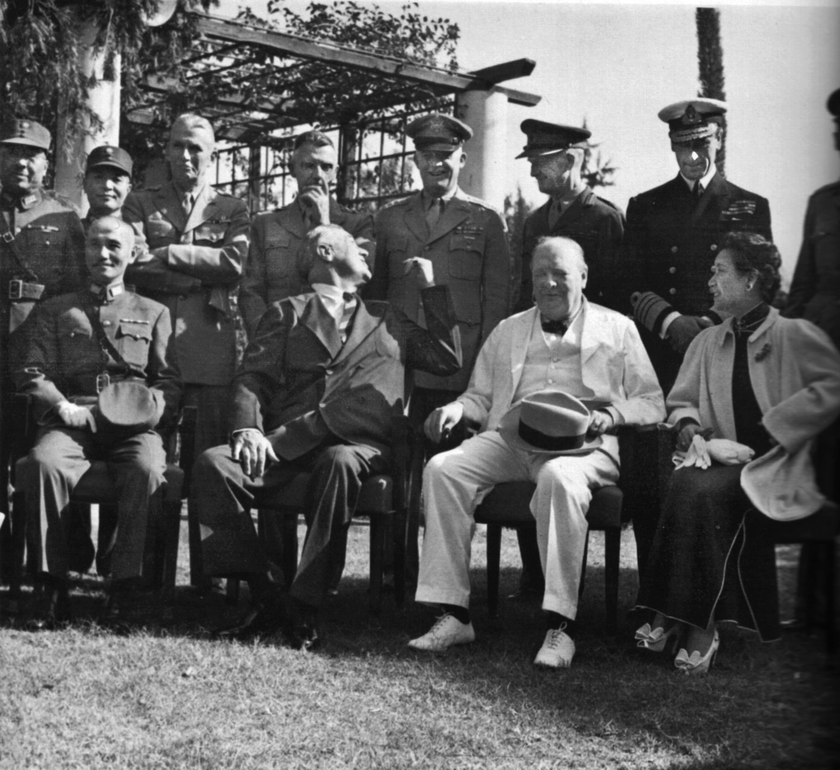 Chinese leader Generalissimo Chiang Kai-shek, seated left, joins President Roosevelt, Prime Minister Churchill and Madame Chiang during their conference in Cairo, immediately before the meeting of the Big Three at Tehran. Military officers behind the national leaders include U.S. General Brehon Somervell, U.S. General Joseph Stillwell, U.S. General Dwight D. Eisenhower, British Field Marshal Sir John Dill, and British Lord Louis Mountbatten.