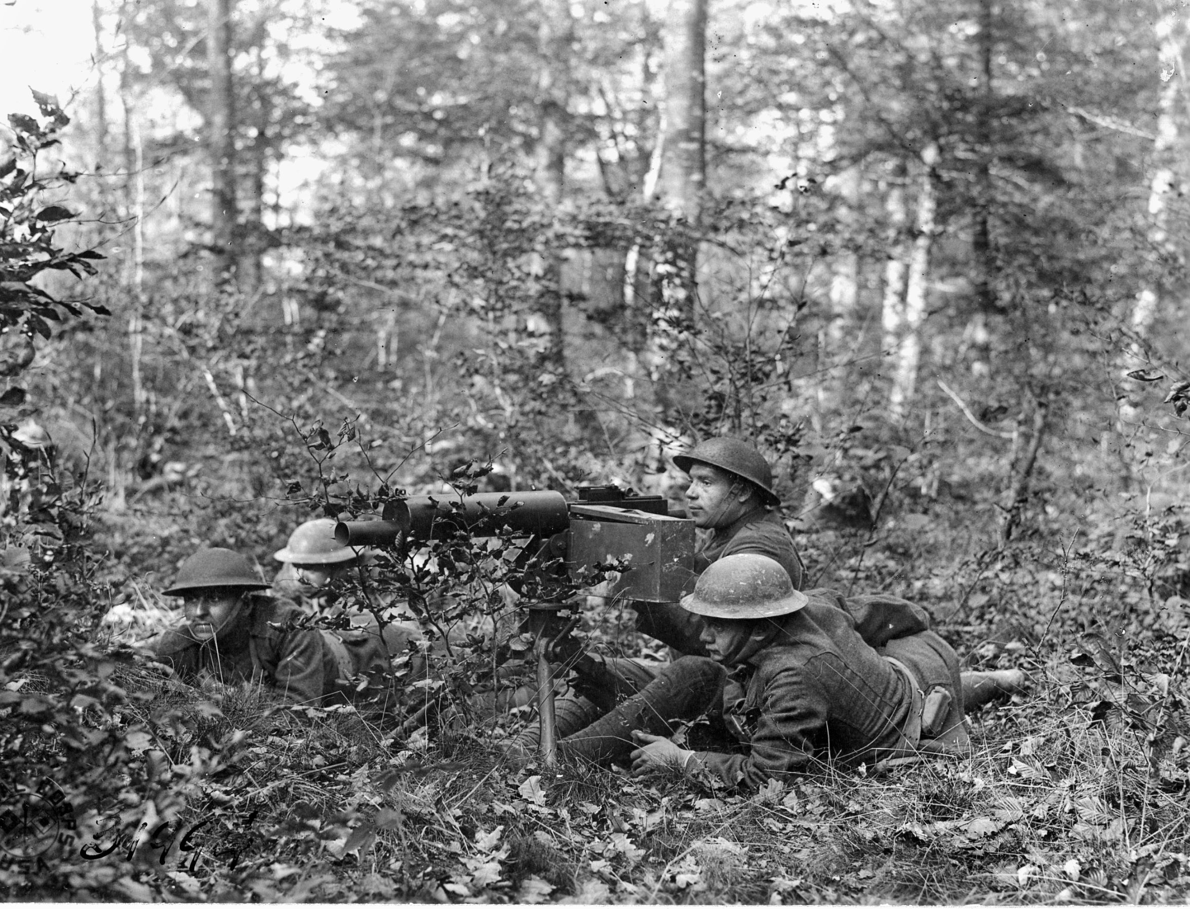 Wary members of the 315th Machine Gun Battalion advance through the woods between La Chalade and Ciaon during the American offensive in the Meuse-Argonne sector. 