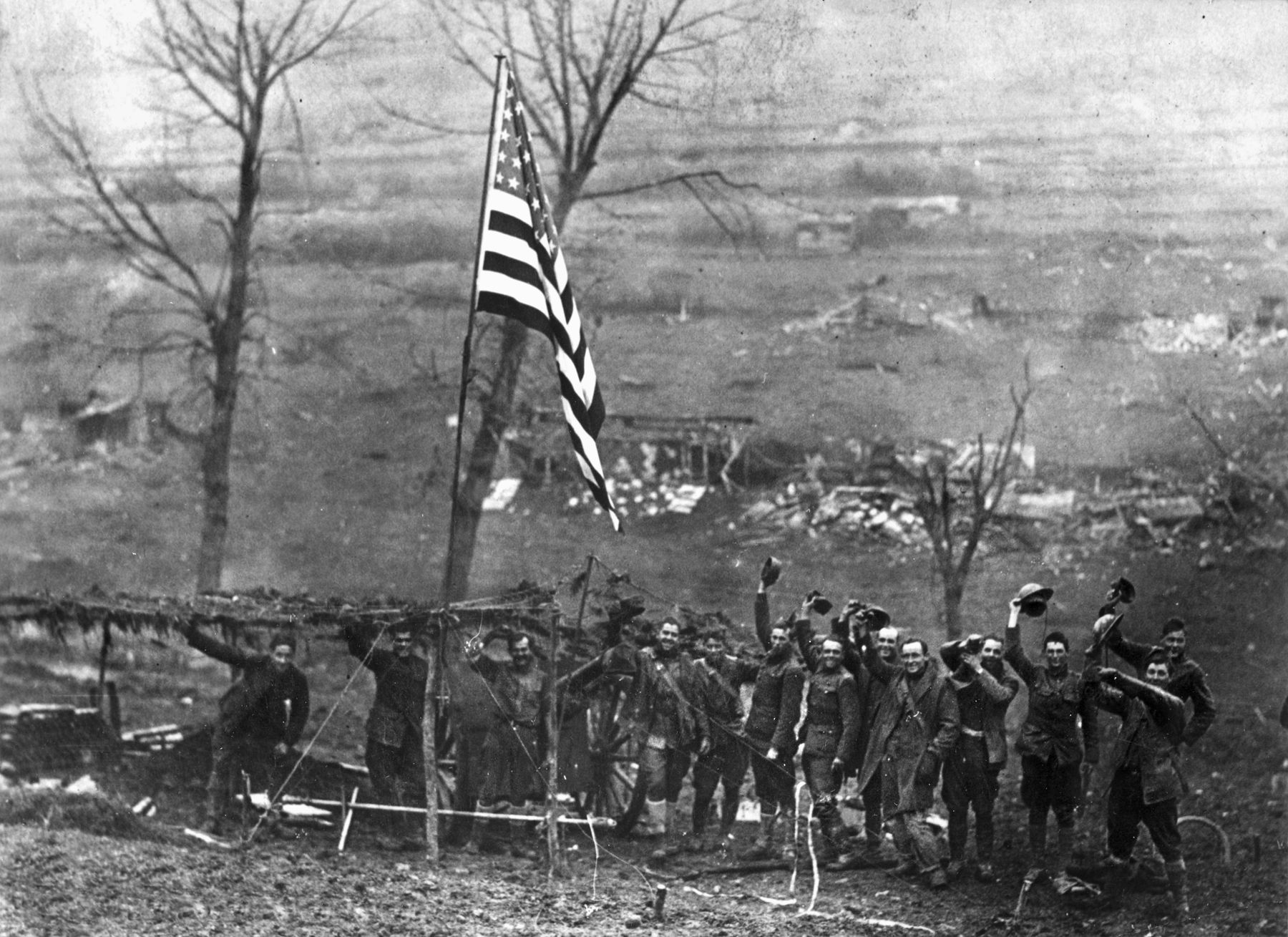 Now quiet, one of the guns of Battery D, 105th Field Artillery, flies a large American flag at Etraye, France, after the armistice took effect on November 11, 1918.
