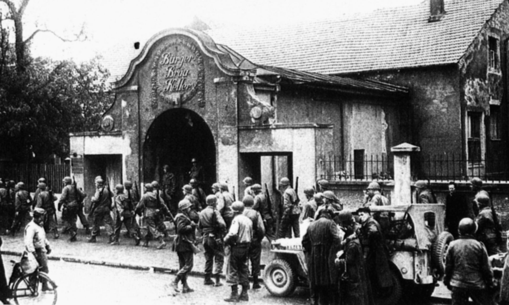 American GIs outside the main entrance to the Burgerbraukeller in April 1945. The beer hall was later replaced by a hotel.