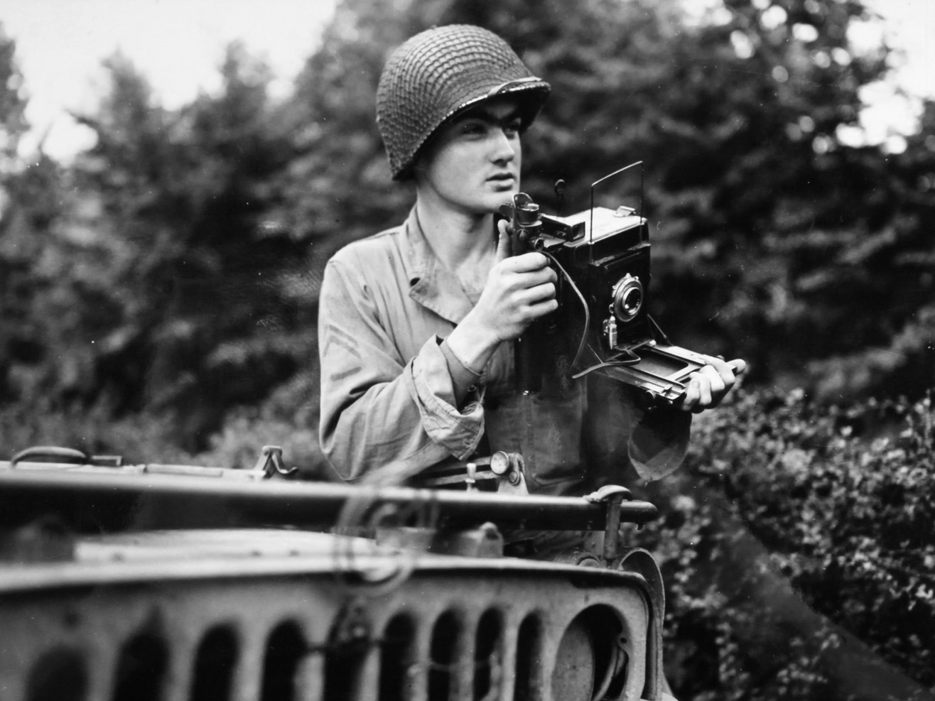 Corporal Hugh McHugh, shown with his 4x5 Speed Graphic PH-104, was killed by a sniper January 15, 1945 in Belgium.