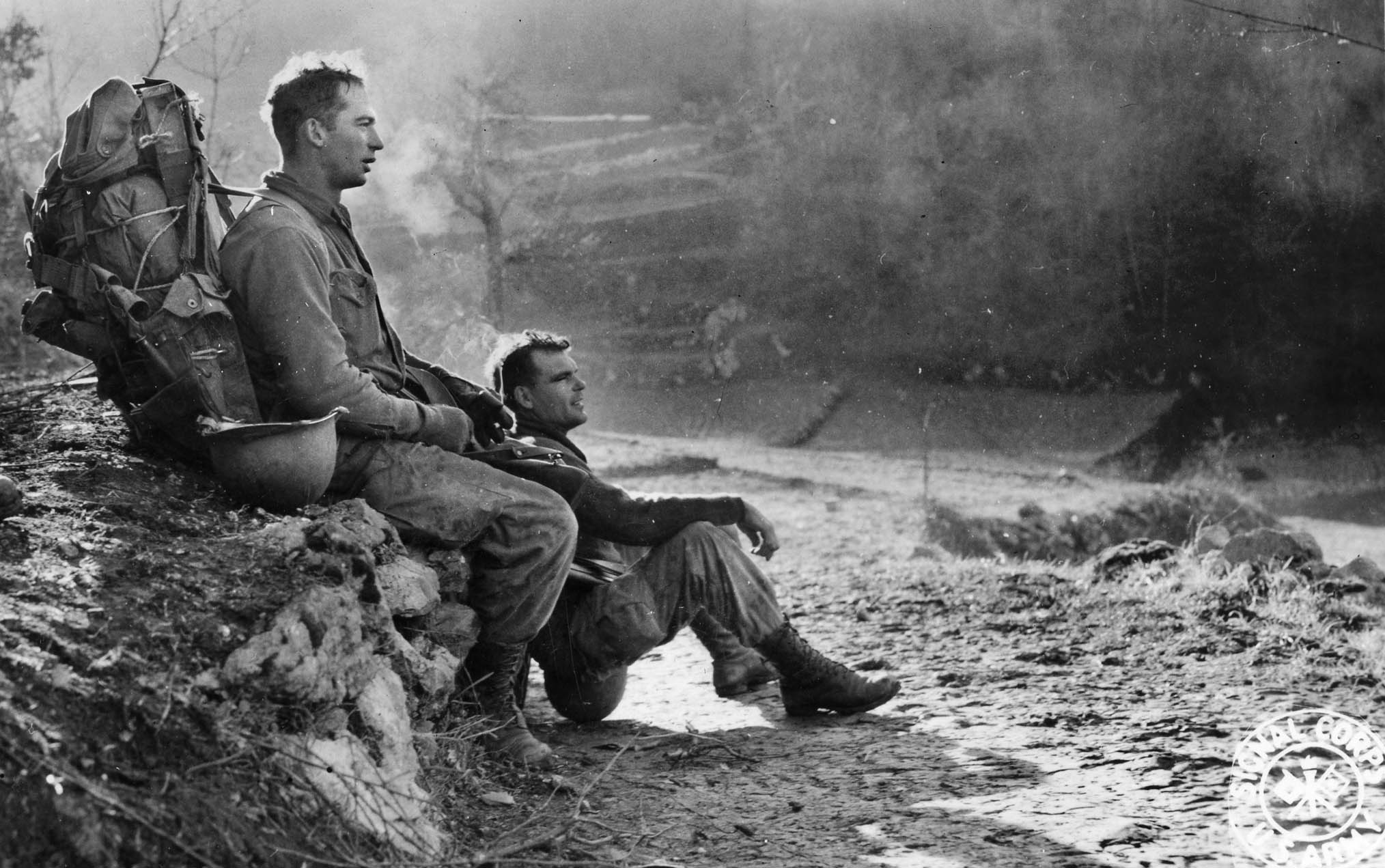 A heavily laden Force man and his buddy take a break during a march near Cevaro, east of Cassino, January 1944. Within a month they would be fighting at Anzio.