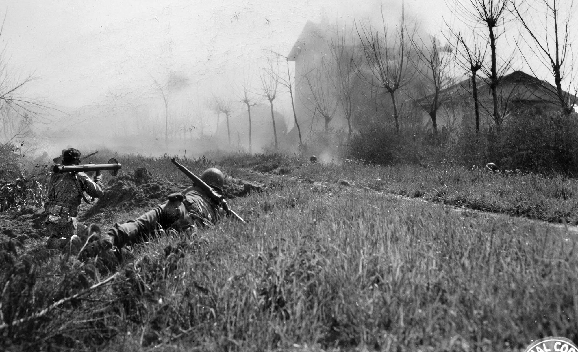A 1st SSF man armed with a bazooka (3.5-inch rocket launcher) fires at a farmhouse near Anzio where German snipers are holed up.