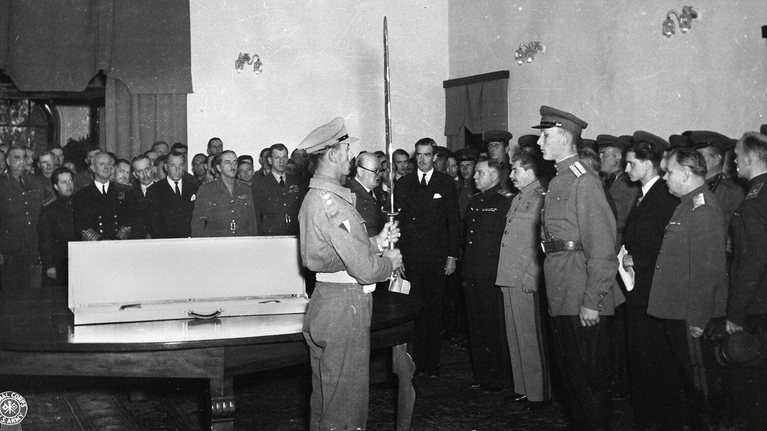 During a ceremony at the Soviet embassy in Tehran, Josef Stalin is presented the Sword of Stalingrad by the British delegation to the Big Three conference. Prime Minister Winston Churchill is visible to the left of the sword.
