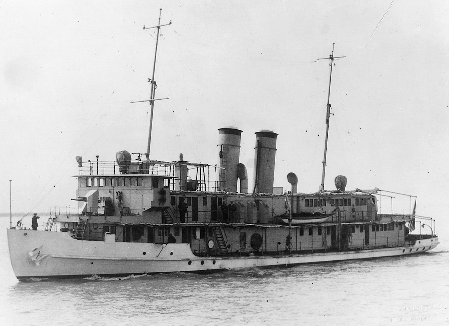 Her coal bunkers full for an extended voyage, the USS Guam rides low in the water of a Chinese river.