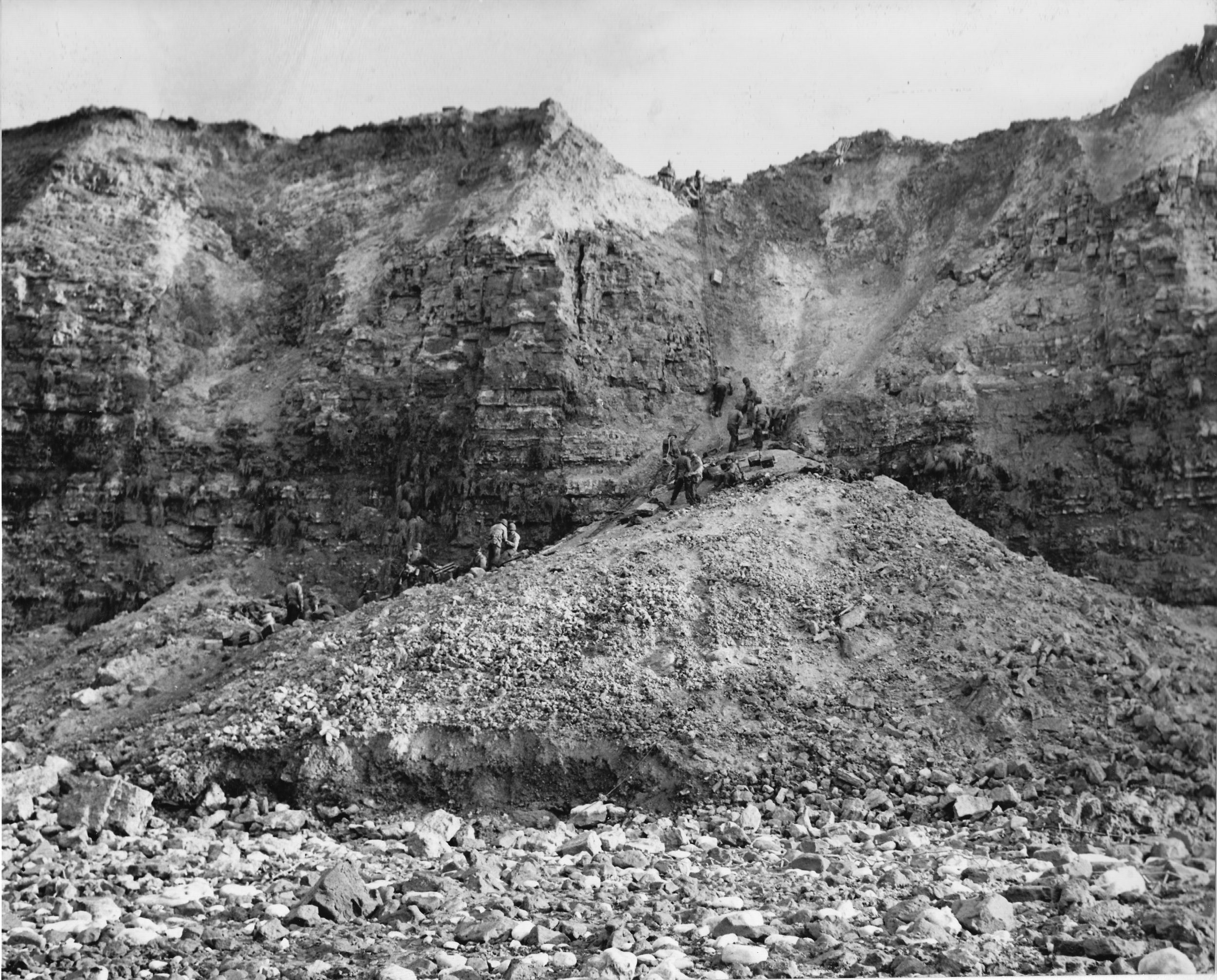 Using a mound of rubble created by shelling that made the initial climb during the attack somewhat shorter, Rangers raise supplies to the top of Pointe du Hoc. 