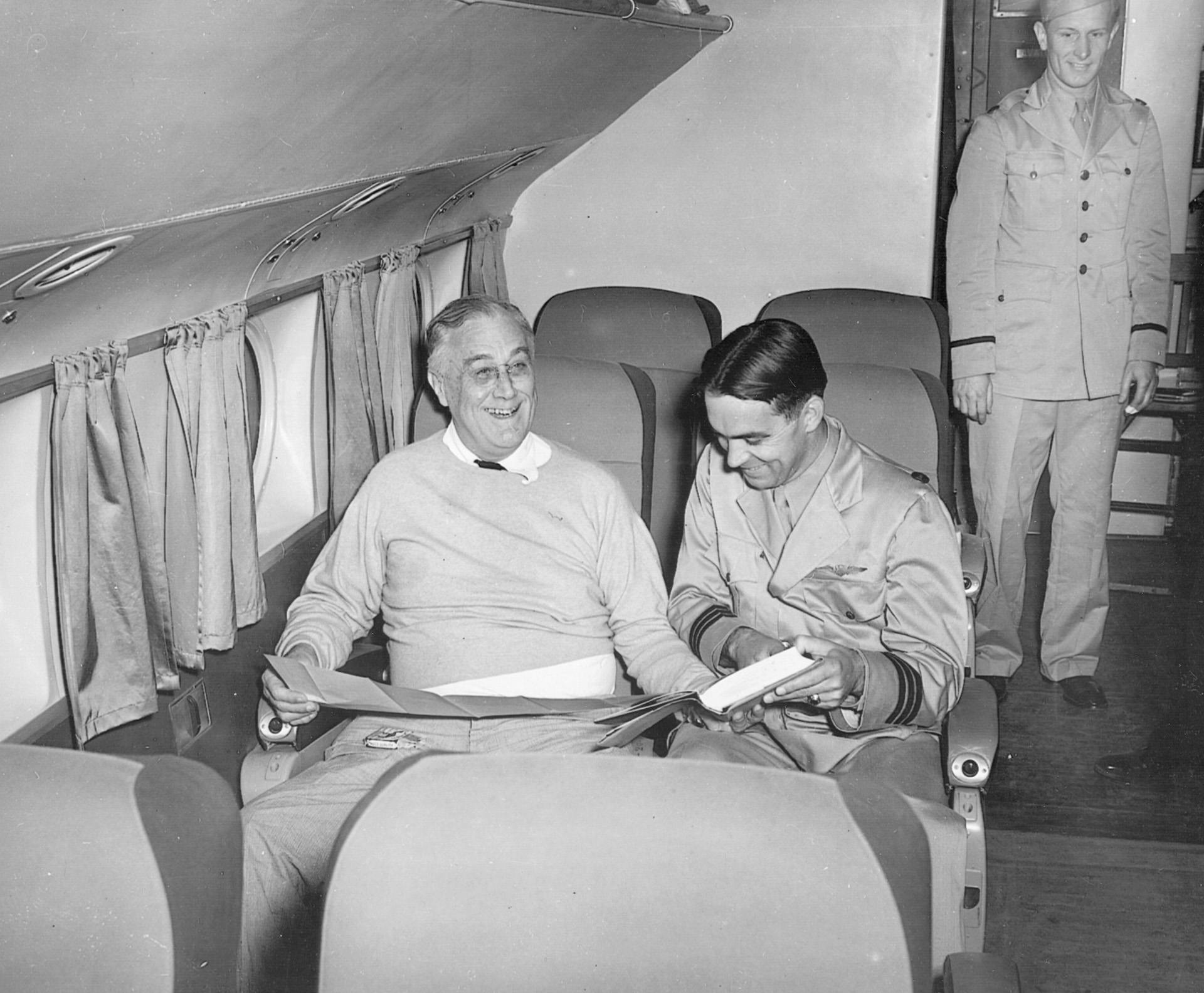 Roosevelt smiles for the camera aboard a Boeing Clipper with Captain Otis Bryan in January 1943.