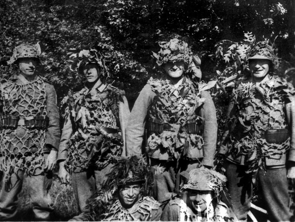 Well-camouflaged German troops smile for the photographer during a pause in the battle. Despite sometimes superhuman efforts, the Germans failed to stop Patton’s juggernaut.
