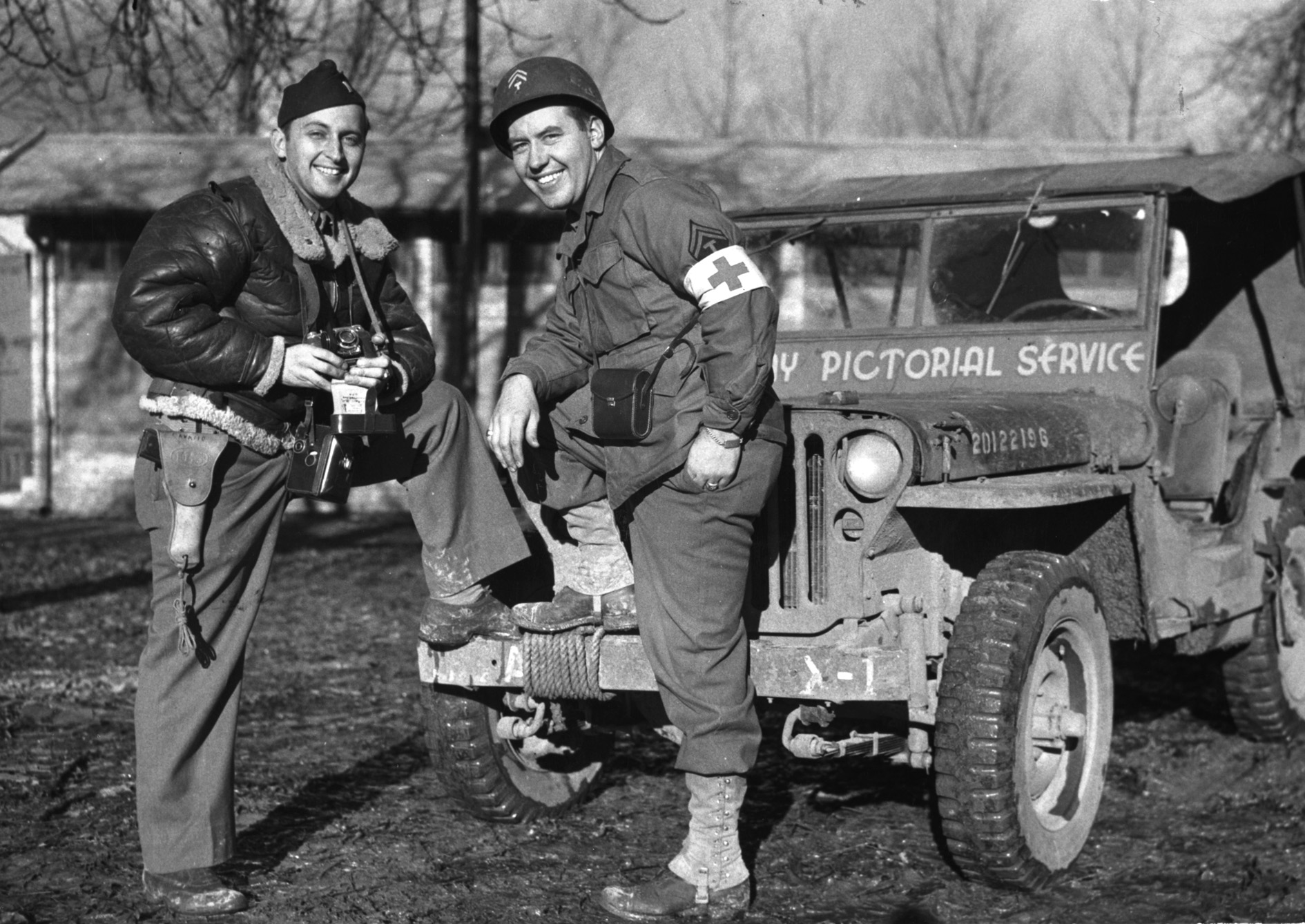 Lieutenant WIlliam Wilson chats with a medic. Note the jeep windshield frame that says it belongs to the Army Pictorial Service.