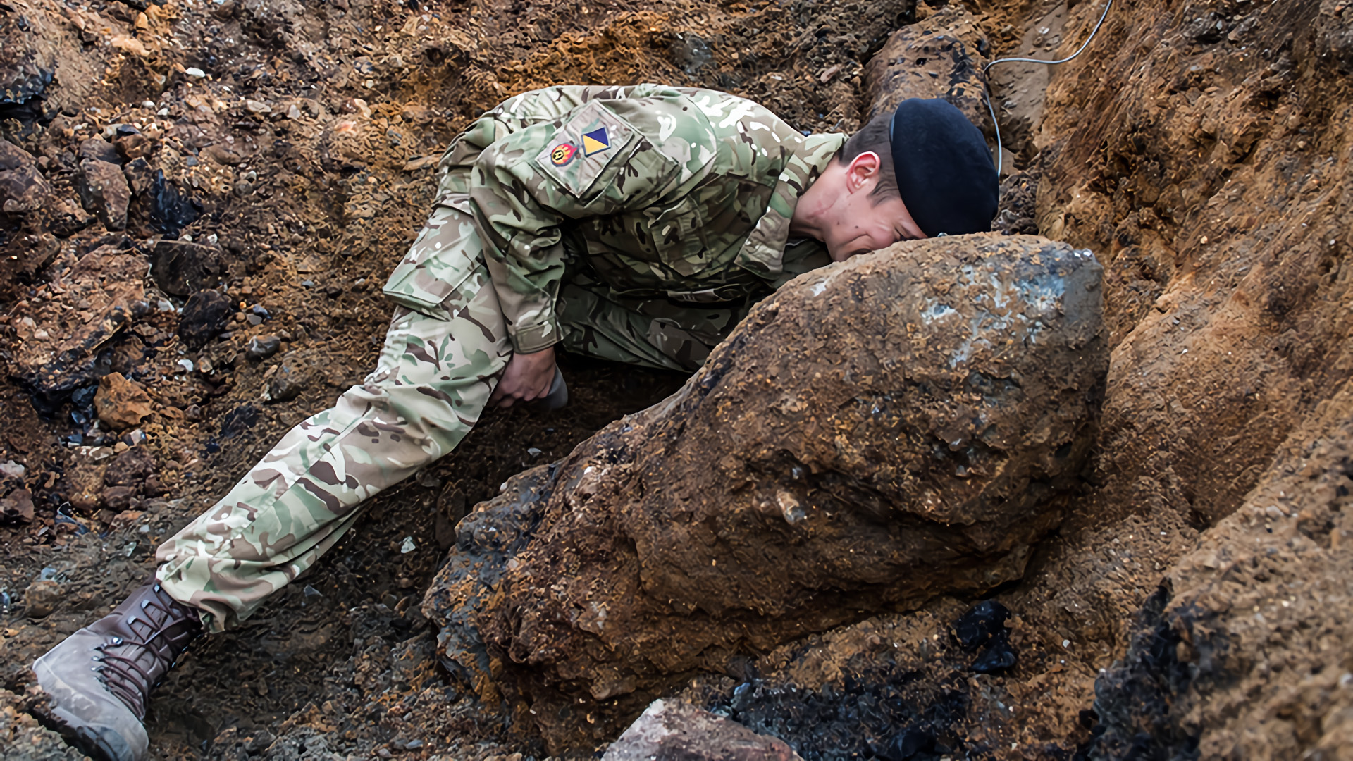 British army bomb disposal expert works on World War II era German bomb discovered in London in 2015.