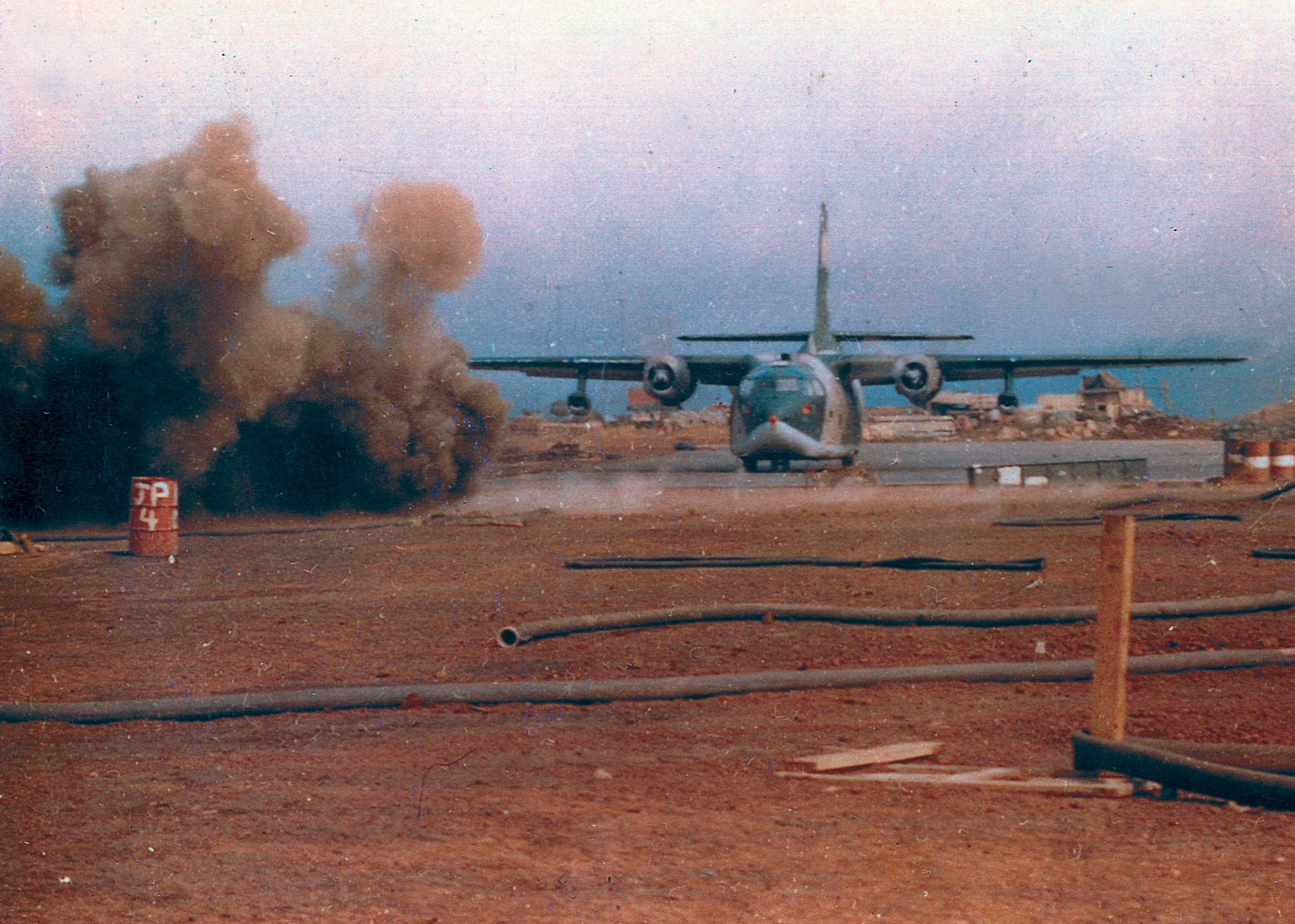 Landing under enemy fire, an American C-123 touches down unscathed at Khe Sanh.