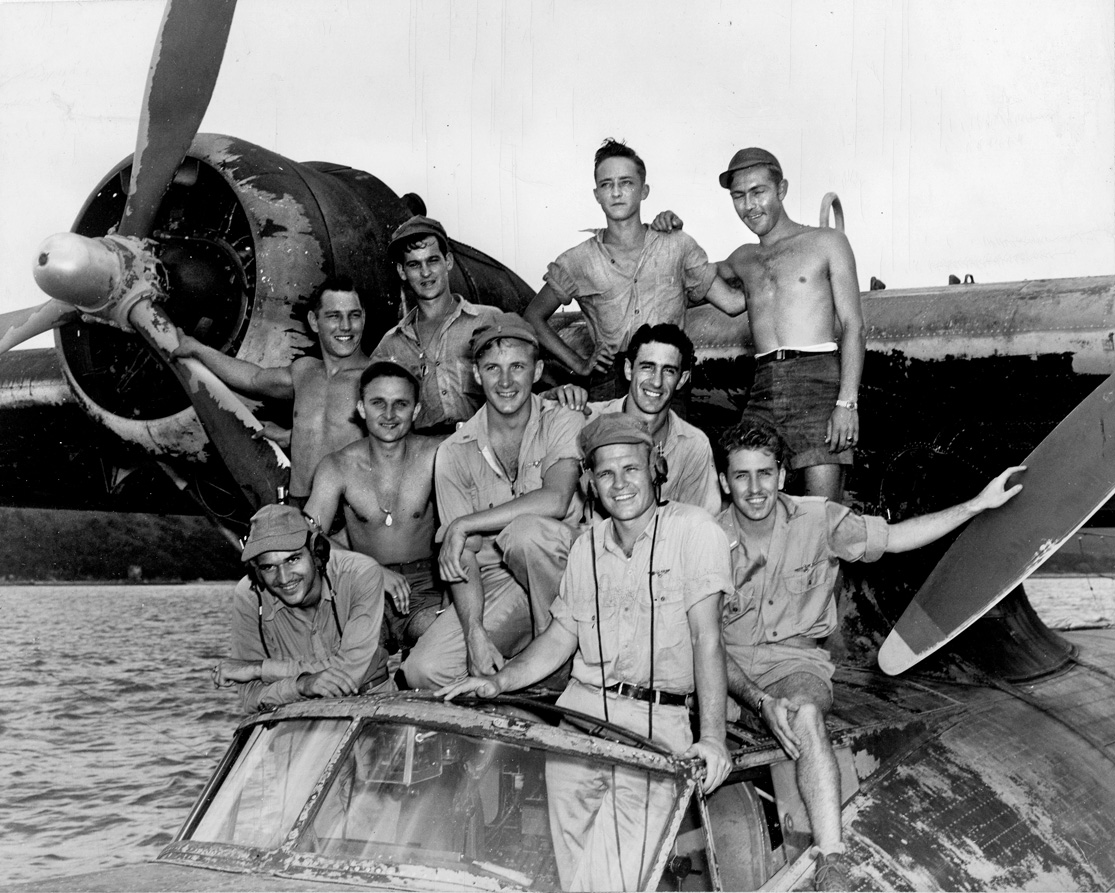 Lieutenant Nathan Gordon, whose heroic acts saved several lives on February 15, 1944, stands at front with the crew of his Consolidated PBY-5 Catalina flying boat nicknamed Arkansas Traveler. Gordon received the Medal of Honor for his valor. 