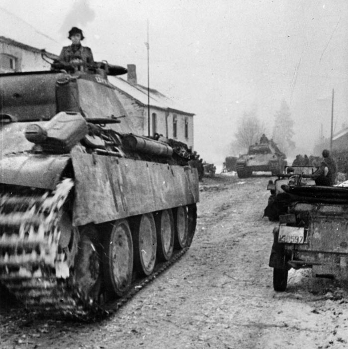 German Panther tanks advance west through a Belgian village. The German goal for the campaign was Antwerp, but the stubborn defense of places like Noville stymied the offensive prior to the Siege of Bastogne. 
