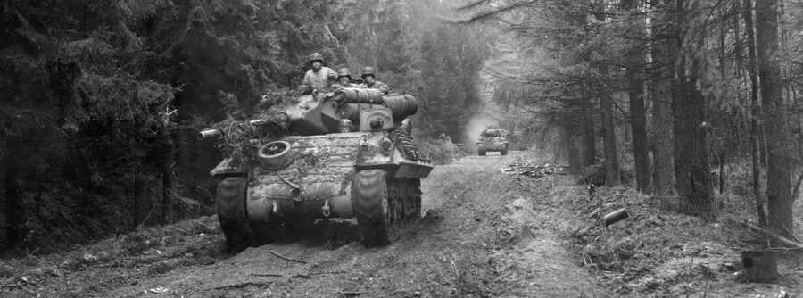 During the fight for the town of Schmidt in the Hürtgen Forest, armored vehicles of the 893rd Tank Destroyer Battalion roll forward in support of a 28th Infantry Division attack.