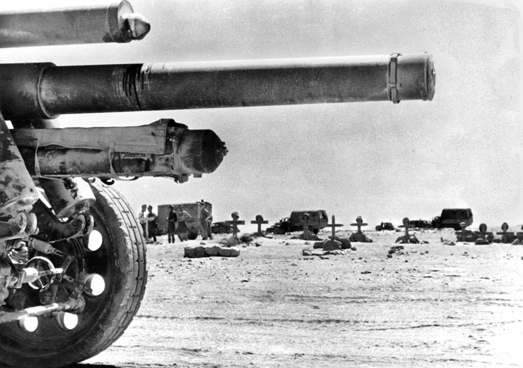 Rommel knelt to capture this photo of German graves in the desert framed beneath a looming artillery gun, circa 1941. He took many photographs of his men's graves throughout his campaigns, evidently to save them as mementos.