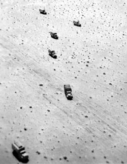 Trucks form a strange asymmetrical pattern as they cross the desert in North Africa, circa 1941-42. This was one of many reconnaissance-type war photos Rommel took from his Fieseler Storch aircraft; while flying, he created many striking photographic compositions.