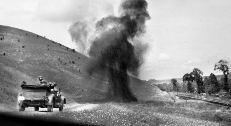 A shell blasts the road ahead of Rommel's vehicle during his advance into France, 1940. In his war photos, Erwin Rommel frequently captured images of explosions and smoke. (NOTE: This photograph, like several others presented here, has been cropped to better fit our website.