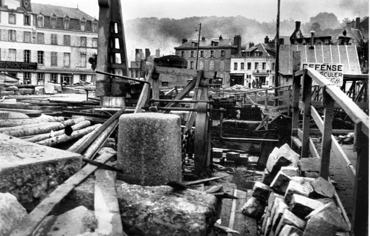 Debris fills the town square of St. Valery-en-Caux, France, following Rommel's bombardment of the city. Rommel frequently photographed patterns and apparent ironies in ruins.