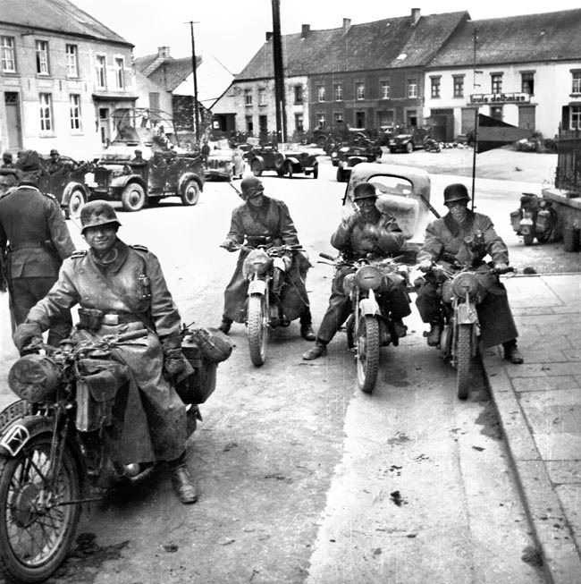 German motorcycle troopers, covered in dust from their advance, pause for a photo in France, 1940.