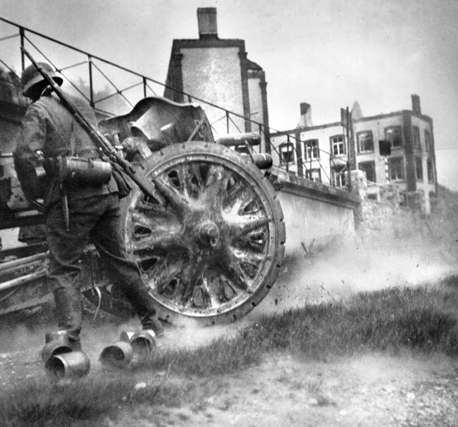 A German soldier fires artillery during the invasion of France, 1940. Rommel sometimes captured action shots from a low angle.