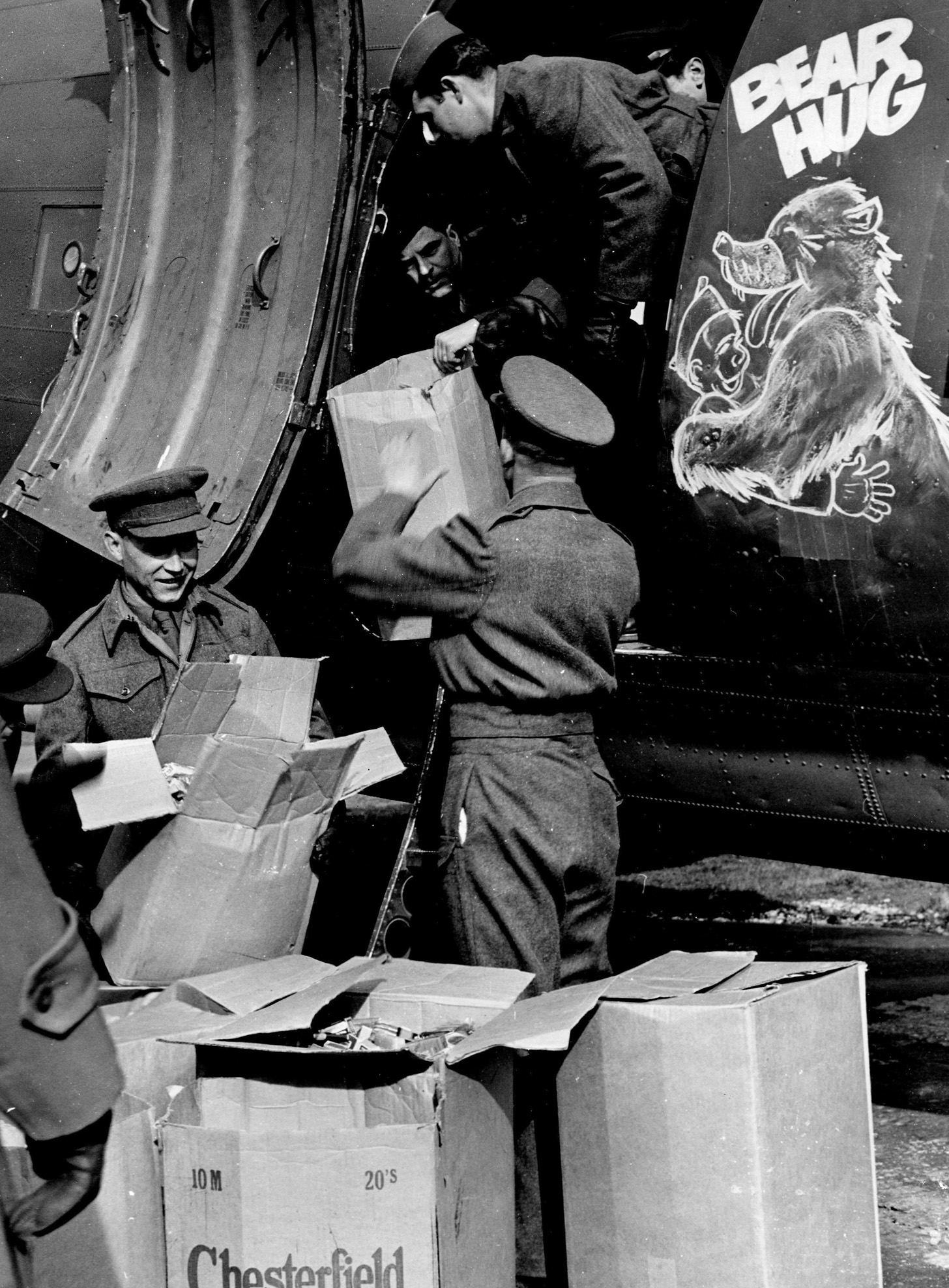Bear Hug, a Troop Carrier Command C-47, is loaded with rations, cartons of cigarettes, and candy to be donated to former Russian POWs waiting to return home.