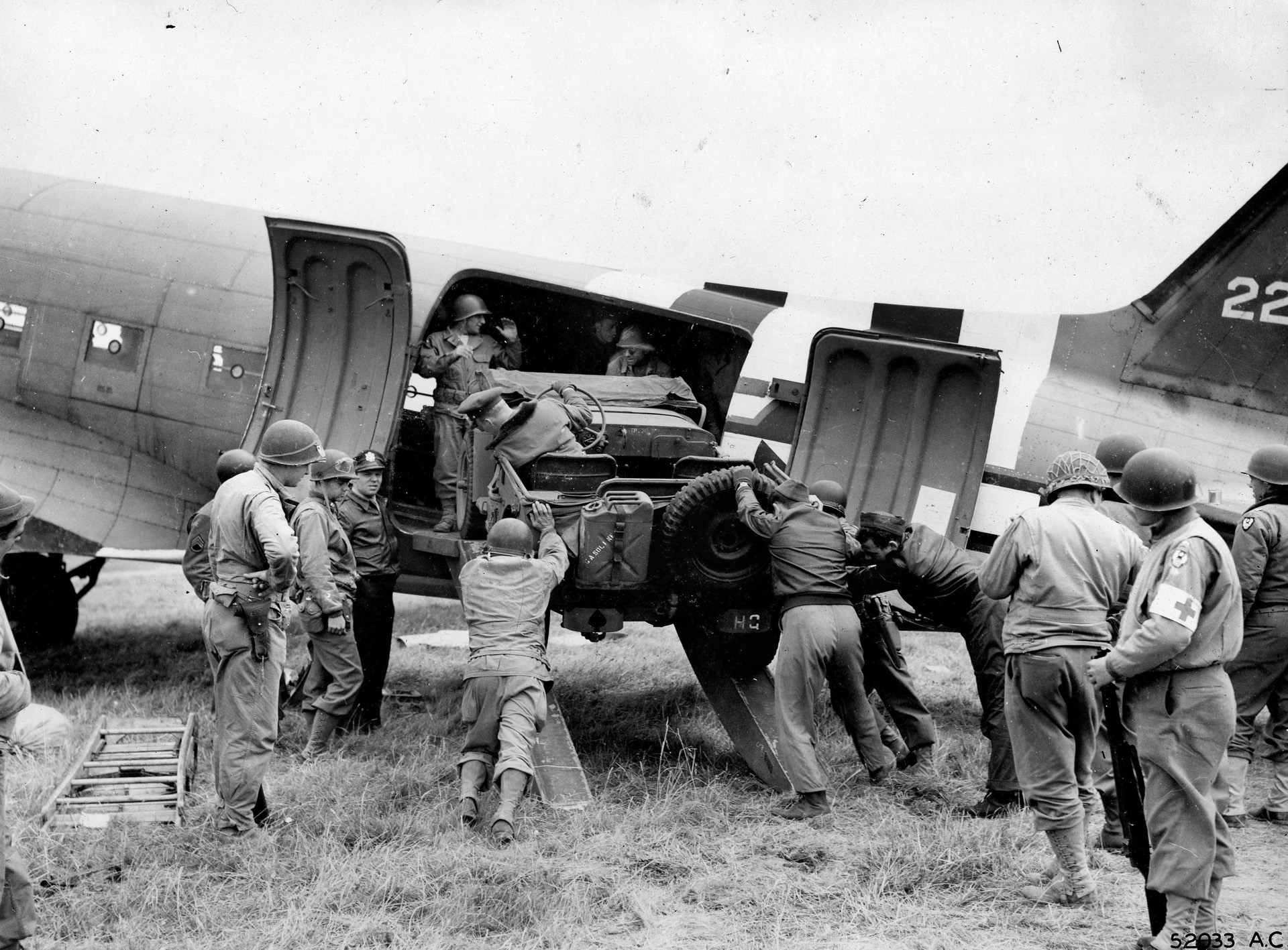 Members of Ninth Carrier Command unload a Jeep from a C-47 on one of the emergency landing strips in France. Without the Troop Carrier Commands, the American war effort in the European Theater would have ground to a halt.