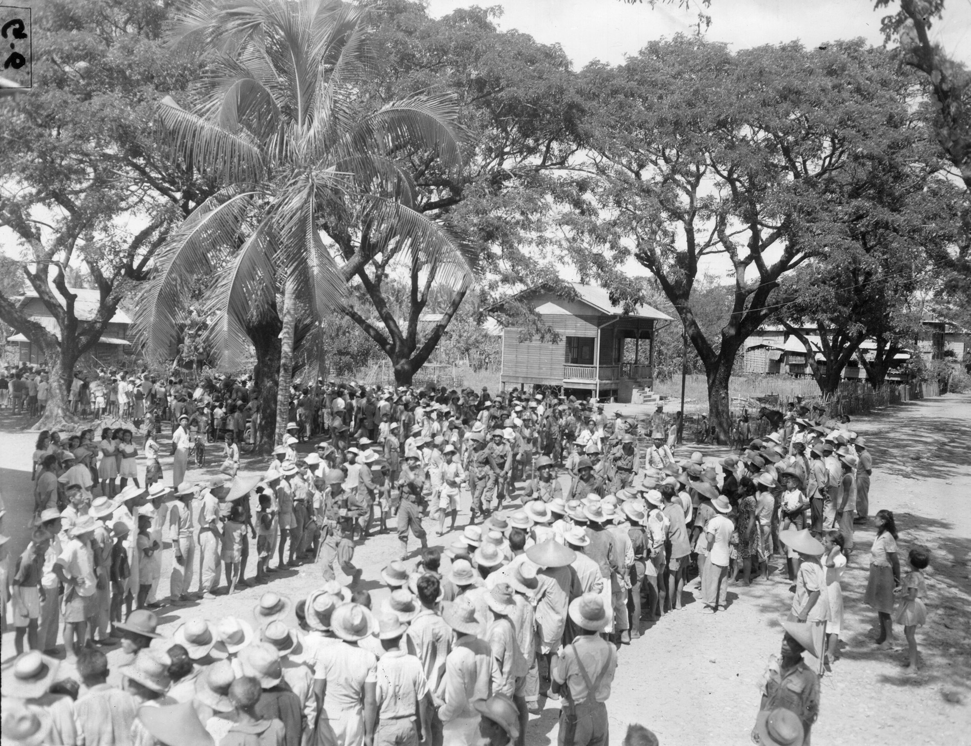 During the liberation of the Philippines on January 29, 1945, American troops are welcomed by the townspeople in the village of San Marcelino on the Bataan Peninsula. The land campaign to wrest the Philippines from Japanese control began in the autumn of 1944.