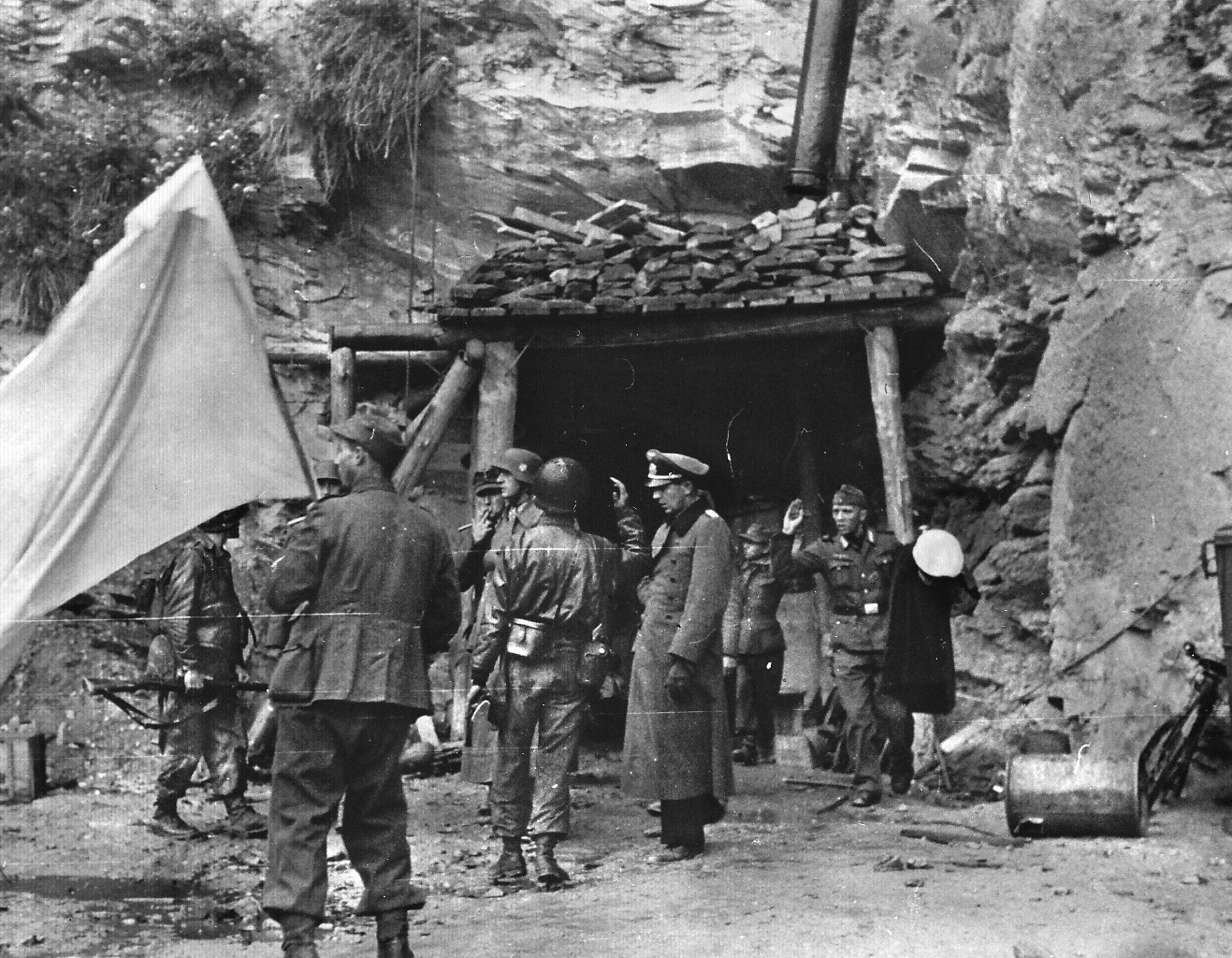 General Wilhelm von Schlieben, commander of the German garrison of Cherbourg, and Rear Admiral Walter Hennecke, commander of the seaward defenses of the city and throughout the region of Normandy, come out of their command bunker to surrender to American soldiers.
