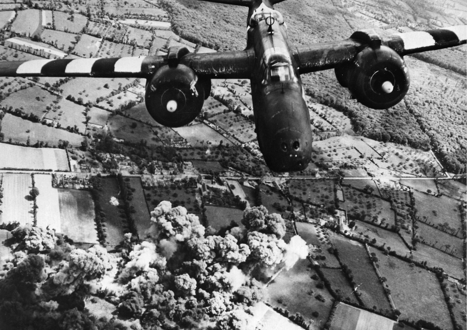 A Douglas A-20 Havoc light bomber of the U.S. Army Air Forces attacks German positions on the Cotentin Peninsula.