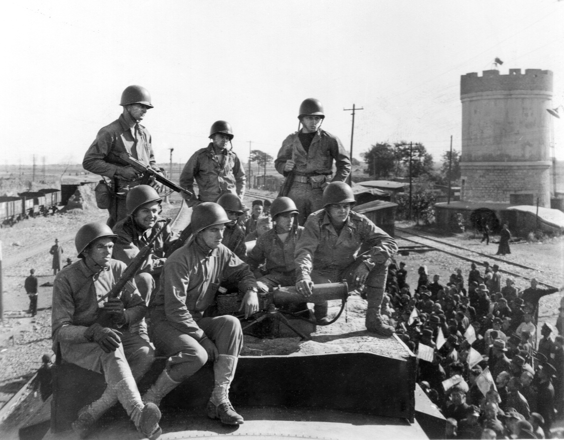 American Marines armed with a Browning .30-caliber water-cooled machine gun and other light weapons pose during efforts to evacuate former Japanese Army personnel after their surrender in China following World War II.