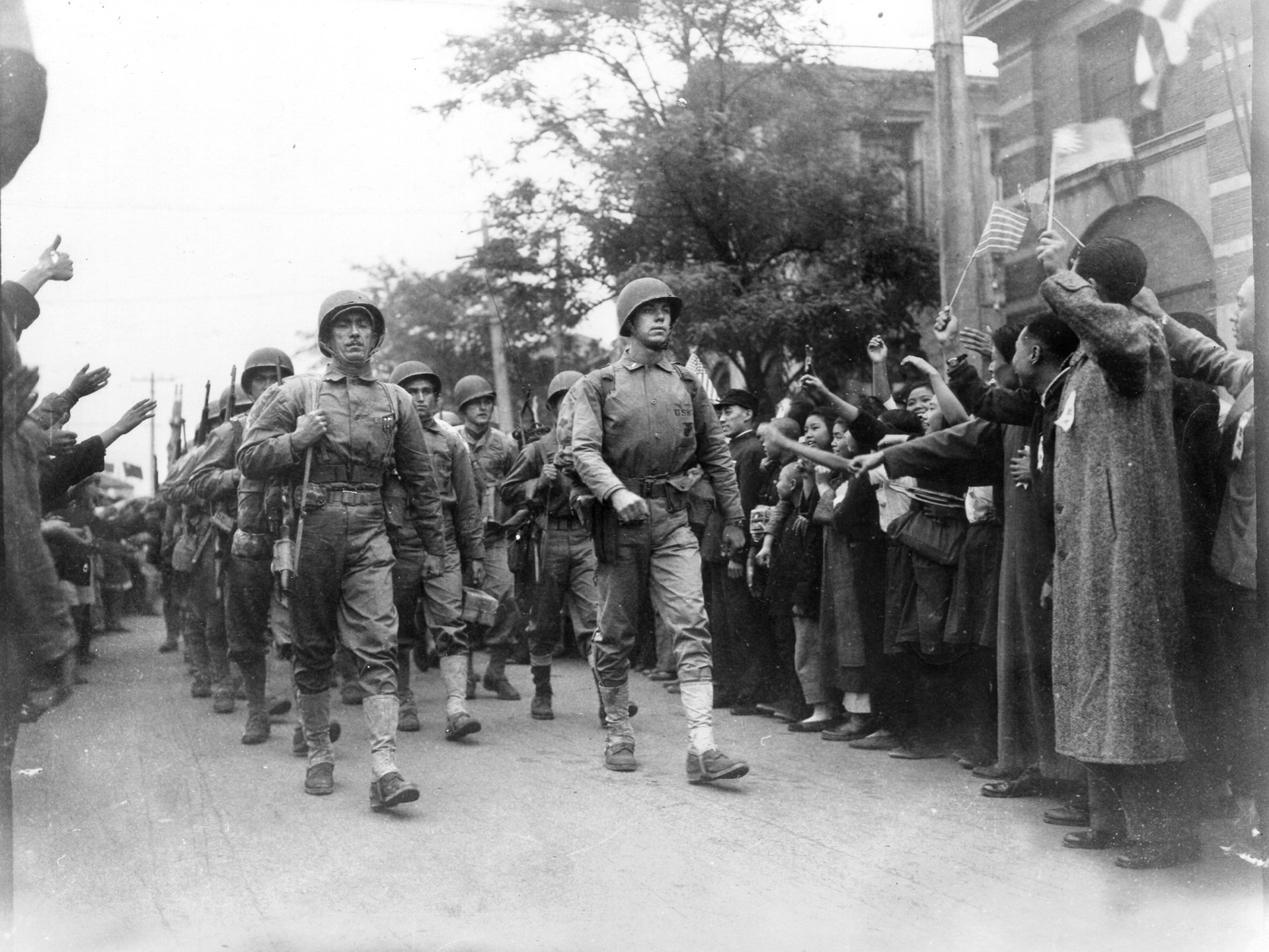 In October 1945, a few weeks after the formal surrender of Japan in Tokyo Bay on September 2, American Marines march into the Chinese city of Tientsin. 
