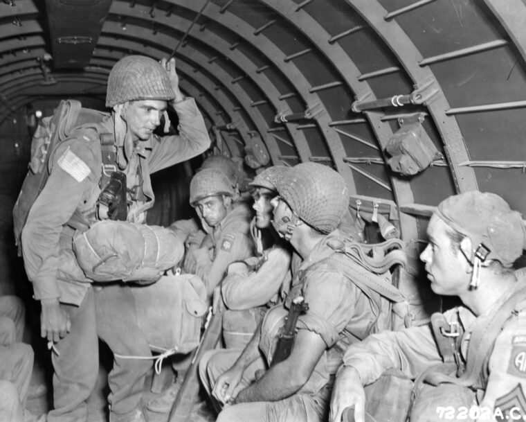 Soldiers of the 82nd Airborne Division talk during the flight from their staging area in North Africa to drop zones on the island of Sicily.