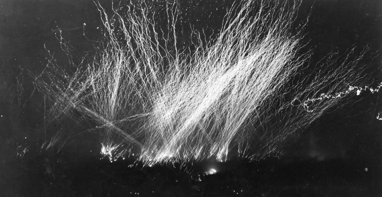 Friendly fire lights up the night sky over the beaches at Gela, Sicily, as American gunners mistakenly open up on paratroopers of the 504th Parachute Infantry Regiment during a follow-up deployment in Operation Husky.  