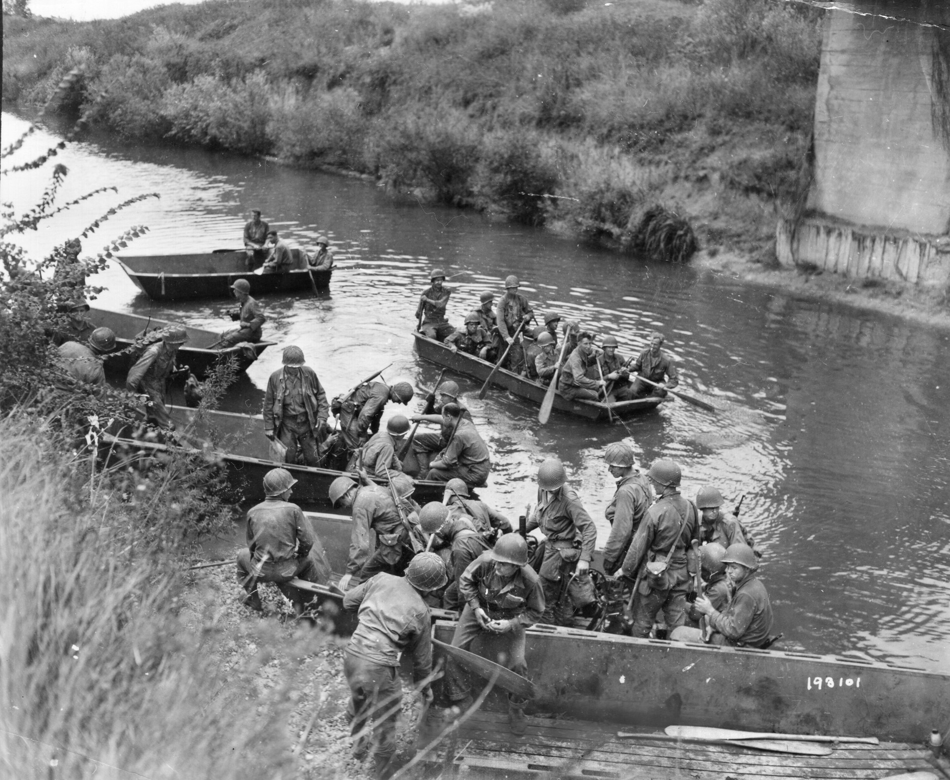 American soldiers board small boats for the movement across the Seine River in northern France on August 20, 1944. This crossing took place near the town of Mantes, a short distance from the French capital of Paris, which was liberated days later.
