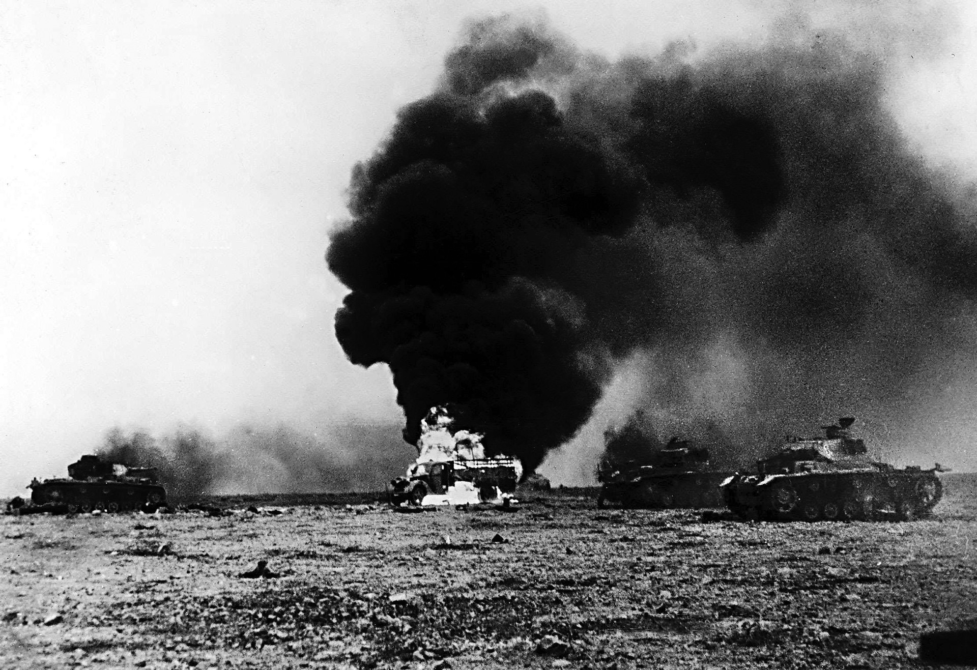 German vehicles, knocked out by South African forces, burn in the Libyan desert, 1941. After North Africa was secured, the South African forces went through a massive reorganization to prepare them for fighting in Italy. 