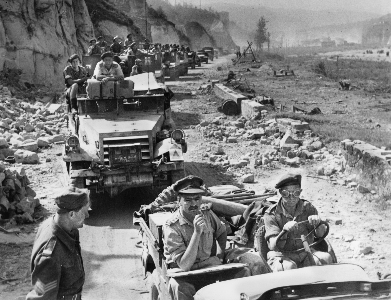 With victory in Italy less than a month away, 6th Armoured Division vehicles advance along a rubble-strewn road near Bologna, April 1945. Fighting in Italy ended on May 2, 1945. 