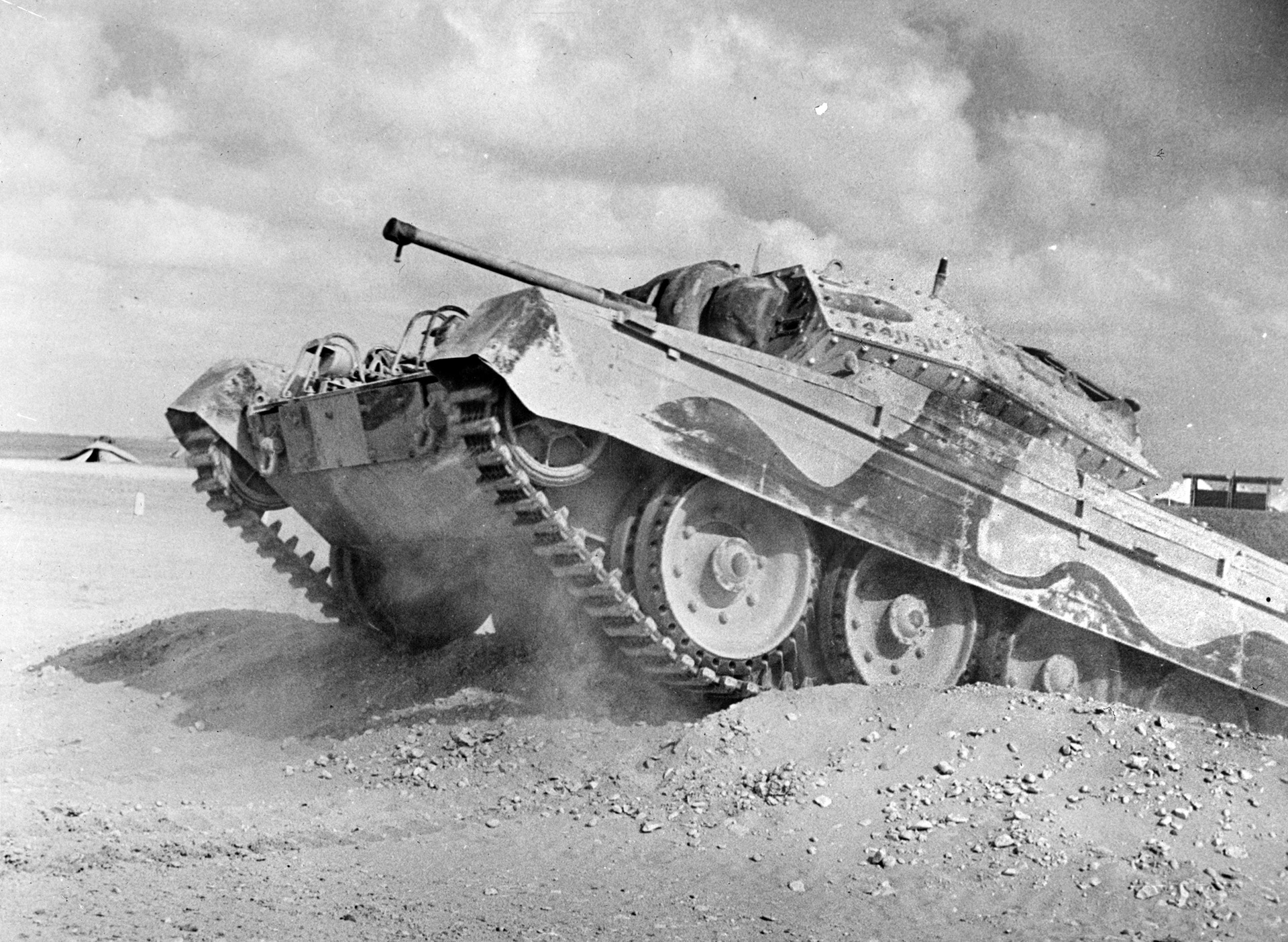 Although woefully inferior to German panzers, the British Crusader tank was issued to the South African division until greater numbers of Shermans were available. Here a Crusader Mk.1 with its relatively ineffective 6-pounder gun and its crew train in a Middle East desert.