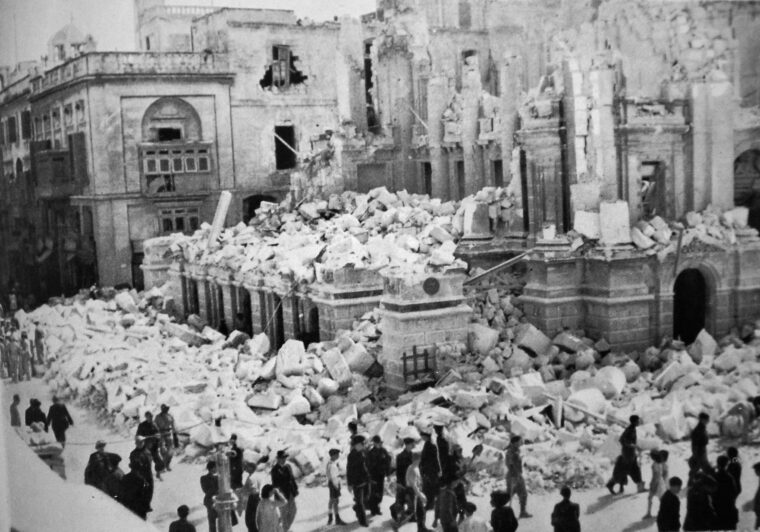 Maltese civilians inspect the ruins of the opera house in Valletta after heavy Axis aerial blitz, April 7, 1942. The British called Malta “the most-bombed island in the world.”