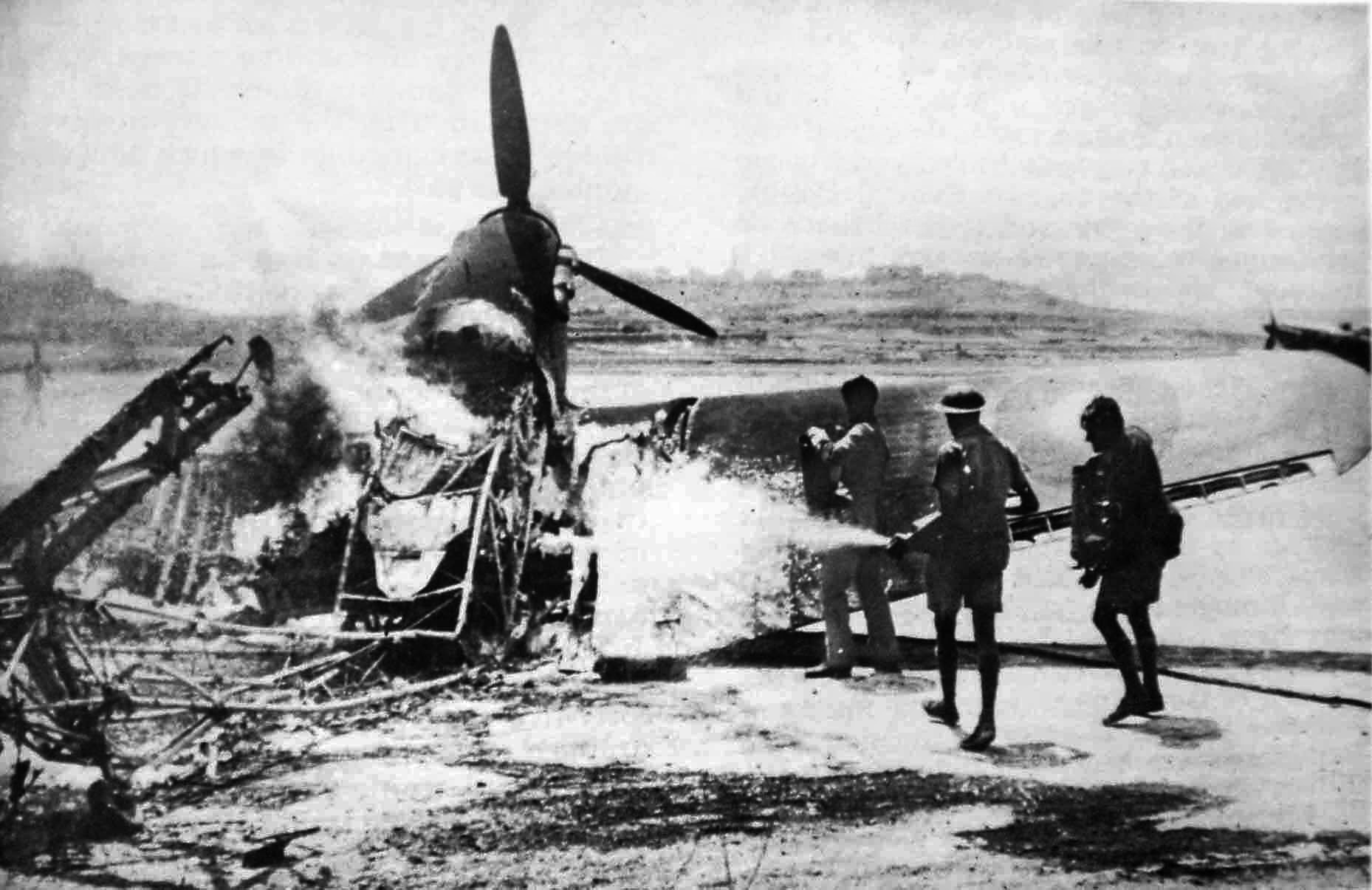 Firemen douse a burning Hurricane, destroyed in a raid on a Malta airfield. The British lost many planes but kept on fighting. 