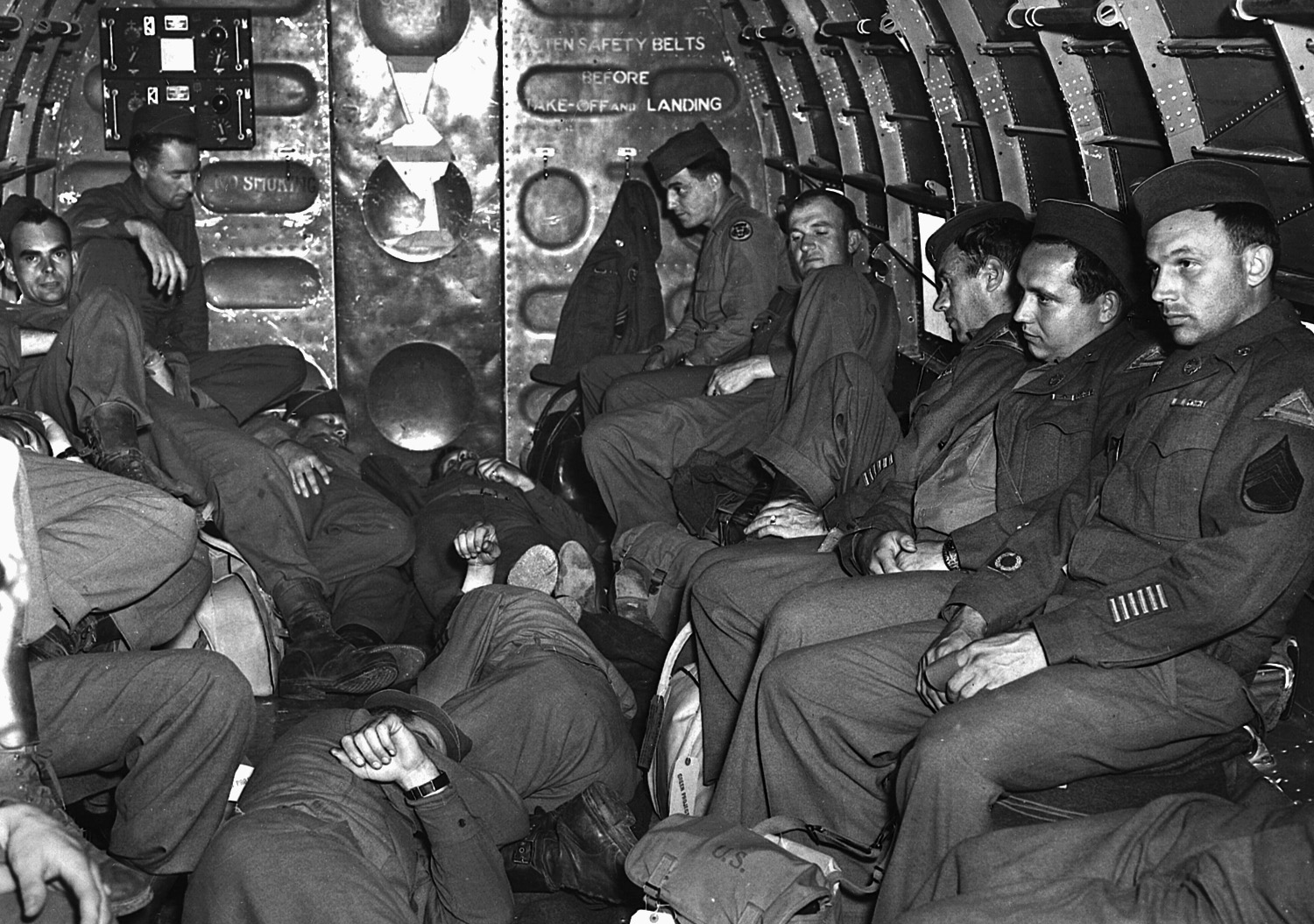 U.S. military personnel endure a long flight home aboard a Douglas C-47 in June 1945. 