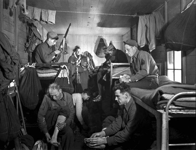 During their arduous training program in Montana, members of the Devil’s Brigade clean their weapons inside a barracks. The Canadian and American soldiers engaged in intense rivalry but became an effective fighting force.
