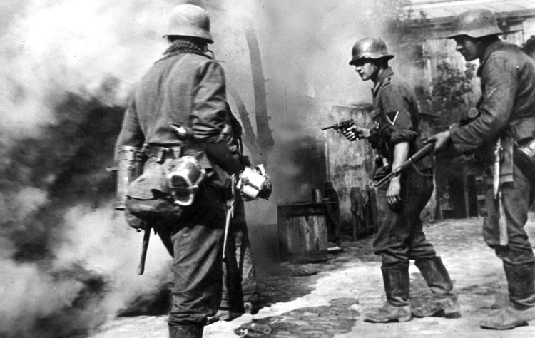 A German soldier holds his 9mm Luger pistol at the ready during operations in a village on the Eastern Front in 1943.